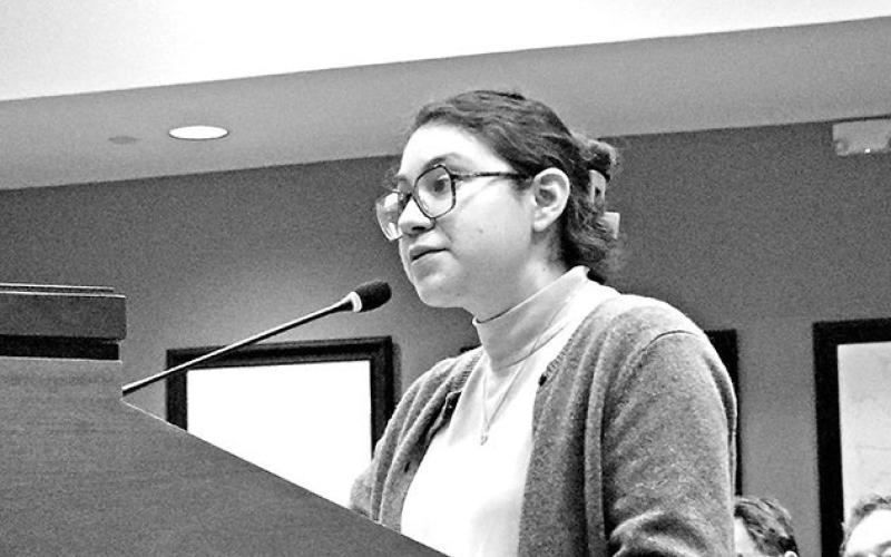 Mt. Pleasant Public Library Director Lupe Herrera presents a grant awarded to the library