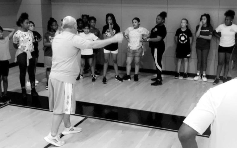 Coach Marshall and Coach Farrier instruct the girls. PHOTO BY CRYSTAL JACKSON