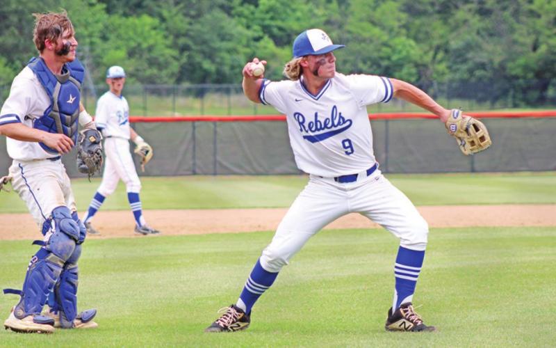 Rivercrest’s Kirk Killian prepares to throw to first for game two’s final out as Zane Dees backs him up. The Rebels defeated Alba-Golden in their bi-district series, 2-0. TRIBUNE PHOTO / QUINTEN BOYD