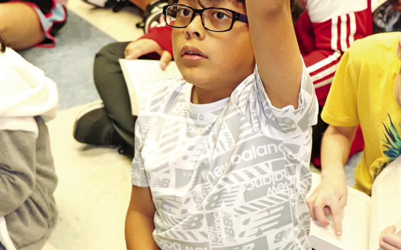 Sims 3rd grader Hatzael Antolin finds an answer in his new dictionary