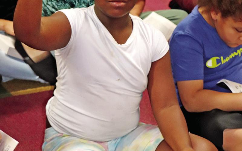Corprew 3rd grader, A’zharia Craddock, demonstrates the letter T in sign language