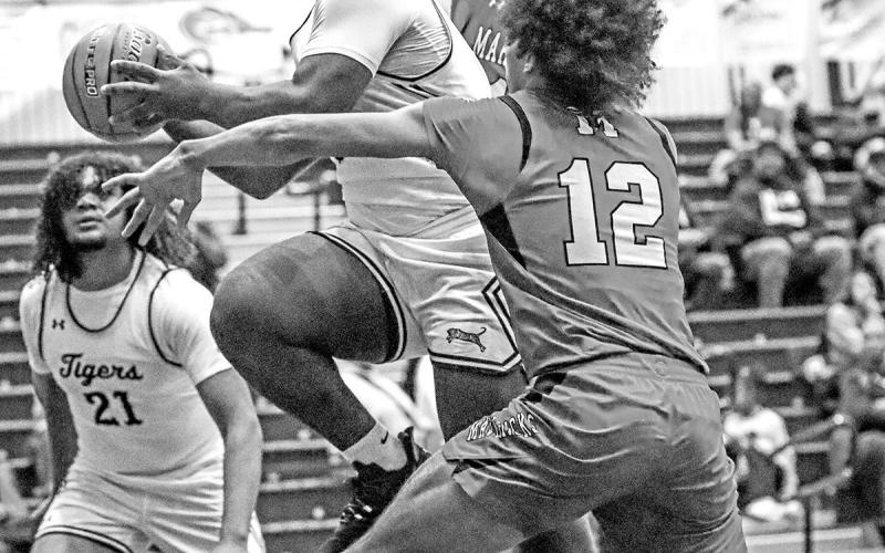 Nemo Savage attacks the paint and scores for the Tigers as they move to 10-1 in district play.