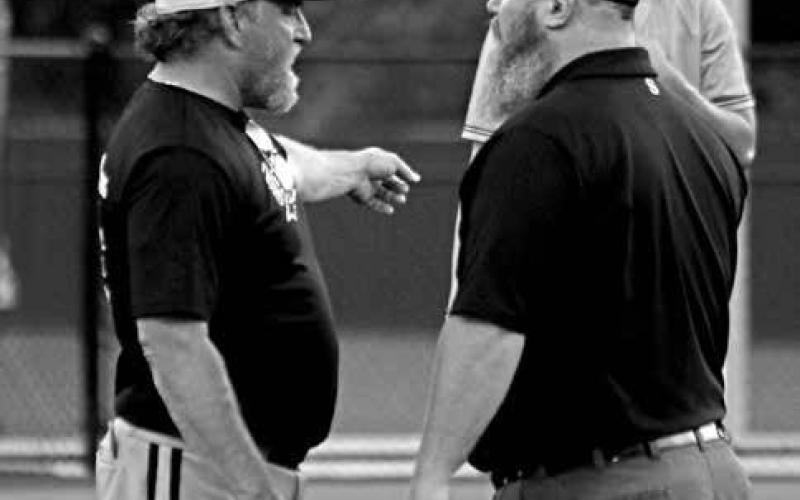 Mount Pleasant Tiger head baseball coach Tommy Stewart has a discussion with an umpire about a balk call during a district playoff game against Texas High last week. Coach Stewart probably has a few more gray hairs after back-to-back, one-run games ended his Tigers’ season this past weekend.