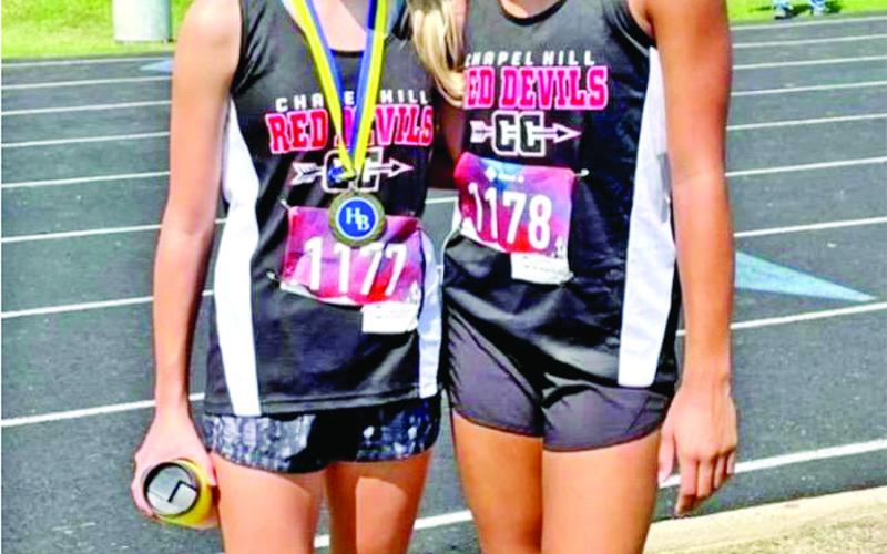 COURTESY PHOTO Chapel Hill JuniorHighrunnerDanielaBaezatookhome1stplacewithatimeof13: 32 ispicturedherewith teammateKaylinBrannon.