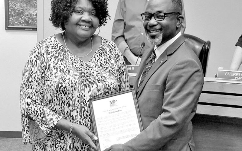 Mrs. Mae Lois Tudman White with City of Mount Pleasant Mayor Tracy Craig, Sr., as the City Council including Councilmember Henry Chappell, II, in the background honored the long-time citizen during the September 6 City Council meeting. COURTESY PHOTO