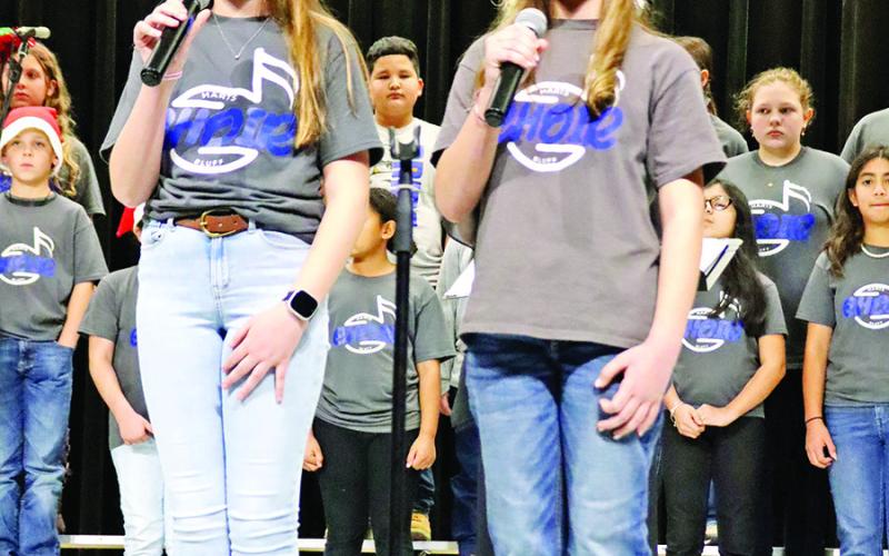 Lankston Holderness and Macie Butler singing “New Kid in Town.” 6th grade