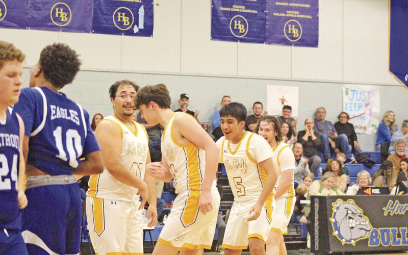 From left, Harts Bluff’s Landon Wisinger celebrates with teammates Brady Cook, Yonathan Bocanegra and Hunter Green after a layup by Wisinger during Friday’s Homecoming game against Detroit. The Bulldogs won, 73-17.