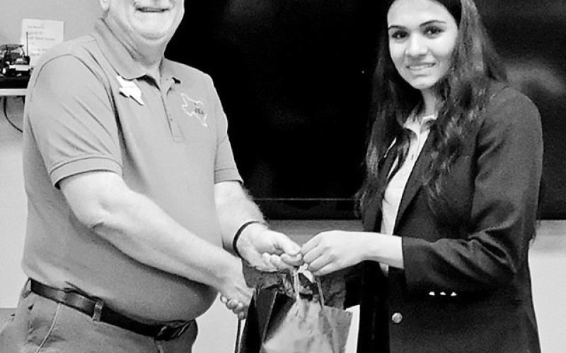 Desai presents Whitten a gift for being a presenter at Officer Training Camp, utilizing her camp training on introducing guest speakers