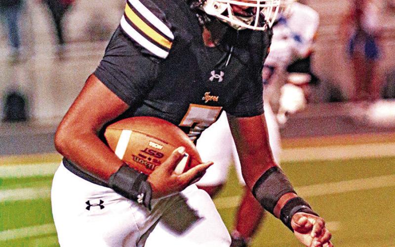 Landon Cheatham catches a pass and turns it up field. Cheatham had three catches and a touchdown for the Tigers.
