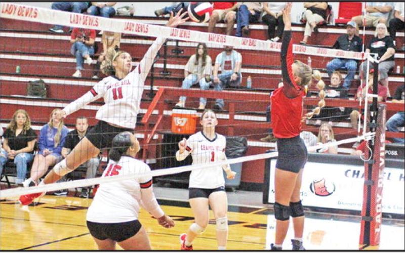 Chapel Hill’s Cailyn Johnson tips a ball over the net while teammates Soraya Solis (left) and Kaylee Tompkins (right) look on. The Lady Devil volleyball team kicked off district play Friday at home against Quitman on the strength of a four-match win streak. Chapel Hill swept Liberty-Eylau and James Bowie, 3-0, won at Pittsburg, 3-1 and picked up a 3-1 win over CHESS Tuesday. The Lady Devils are 13-13 on the season. TRIBUNE PHOTO / QUINTEN BOYD