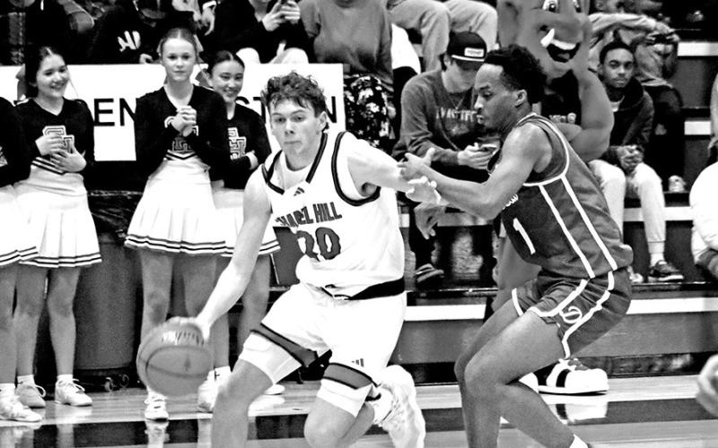 Daniel Dribbles Downcourt Chapel Hill’s Max Daniel (20) dribbles past a Daingerfield defender during a key district game last week. The Red Devils lost to the visiting Tigers, but rebounded with a win over Hughes Springs. They will host league-leading Jefferson this Friday night.
