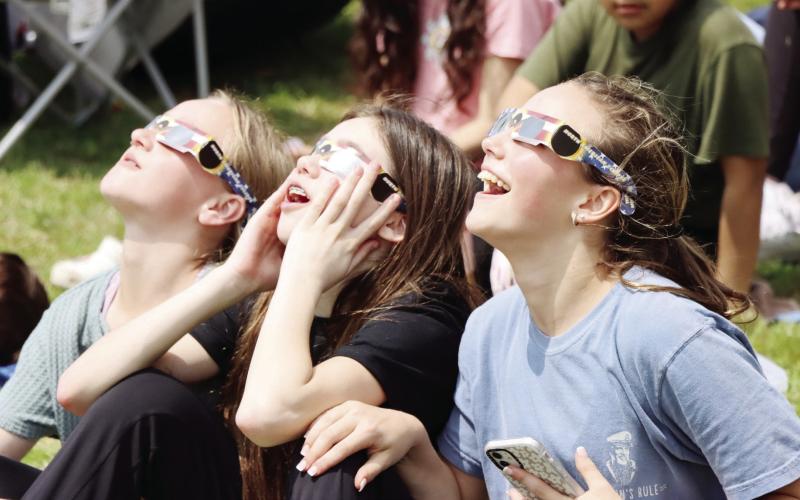 (Above) Local students gathered outdoors to view the total eclipse Monday. (Right) Vendors set up shop during the weekend-long events. For more photos of the events, see page 14. COURTESY PHOTO