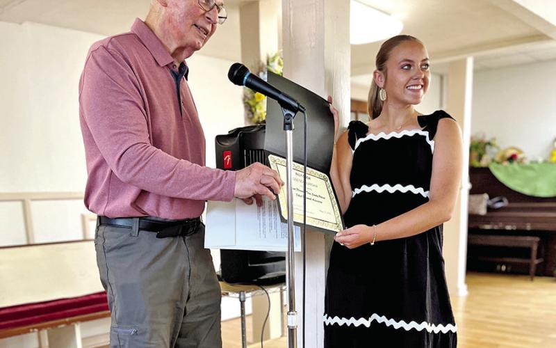 Sam Parker presents Ally Cook with her scholarship.