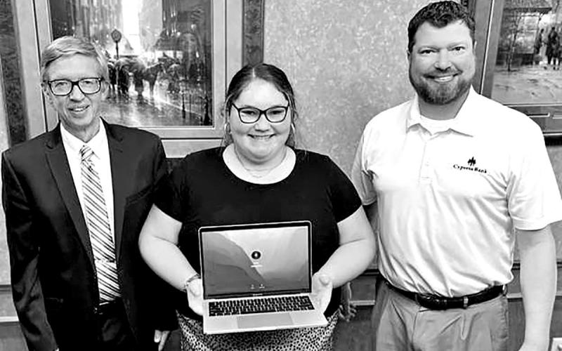 Cydney Carey, center, accepts the Cypress Bank Presidential Scholar laptop from Cypress Bank Vice-President Josh Cato (right). Also pictured is NTCC Honors Director Andrew Yox. COURTESY PHOTO