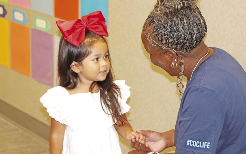 Child Development Center teacher, Tracy Franklin, gets to know a new student.
