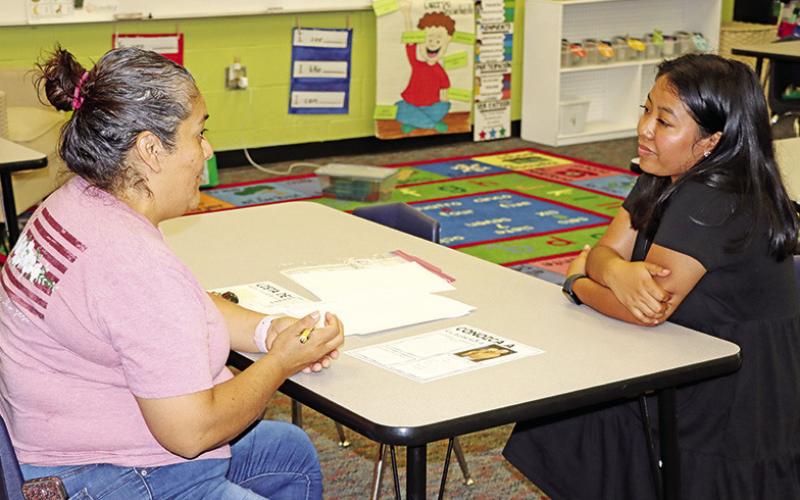 Corprew teacher, Mariana Barboza, meets with a parent.