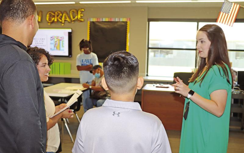 Wallace teacher, Emily, Capel, greets a new family.