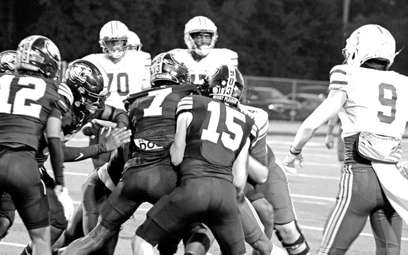 Shane Watkins (7) and Tanner Marshall (15) combine to make a tackle during the Tigers’ game against Sulphur Springs Friday. Watkins recorded four tackles, while Marshall tallied three tackles.