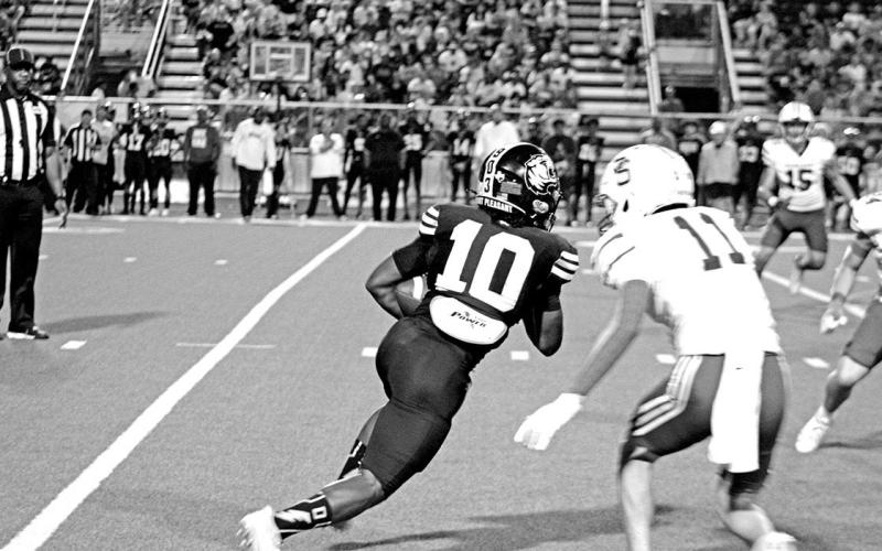 Tony Grant (10) looks for space to run during the Tigers’ game against Sulphur Springs Friday. Grant rushed for 65 yards, and caught one pass for 10 yards in the Tigers’ 24-14 loss.