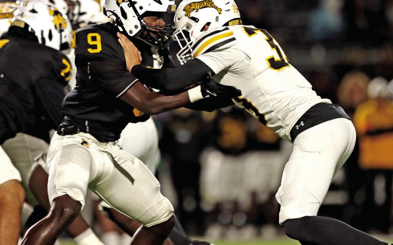 Linebacker Cooper Rider fights through a block just before the half. Rider had 7 tackles for the Tigers.
