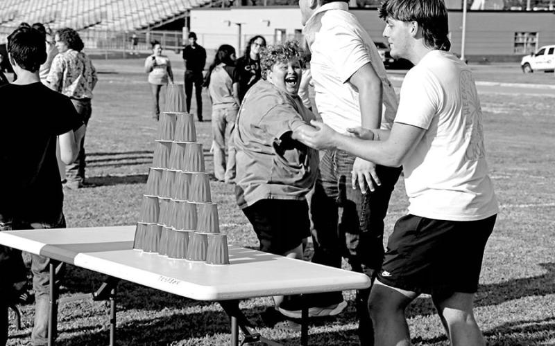 Camden Plowman, Case Rodgers, and Therin Nunn celebrate stacking their cups faster than their opponents