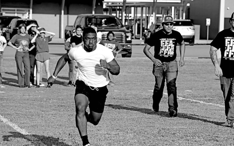 Tony Grant runs his leg of the relay race