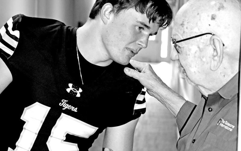 Senior Tanner Marshall discusses football with resident Tilmon Clark.