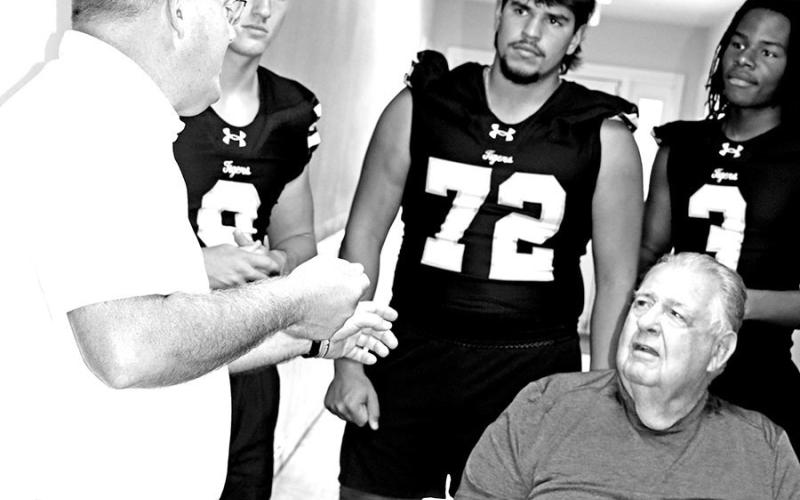 (L to R) MPISD Superintendent Judd Marshall, Carter Cook, Jonathan Amieva, and A’Shad Smith visit with resident, James Shumate. COURTESY PHOTOS