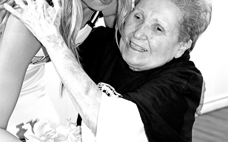 Resident Norma Boyd gets a hug from MPHS Cheerleader and granddaughter, Gabby Zachry.