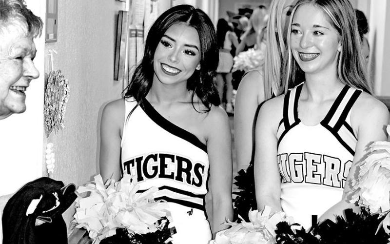 Resident Sandra Ward, who graduated from MPHS in 1954, visits with cheerleaders Aaliyah Delarosa (left) and Rylee Frederking.