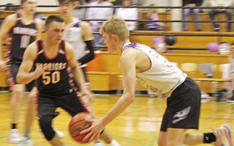 CHAAMP’s John Hall dribbles at the top of the key guarded closely by a Paris defender.