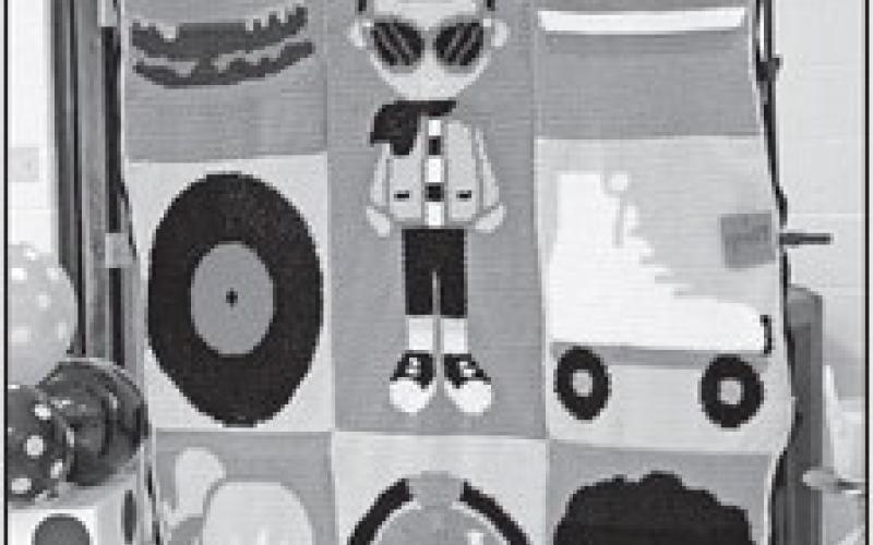 GAZETTE PHOTOS / ELIZABETH LANNING A Sock Hop afghan was raffled for the benefit of the children CASA helps every year.