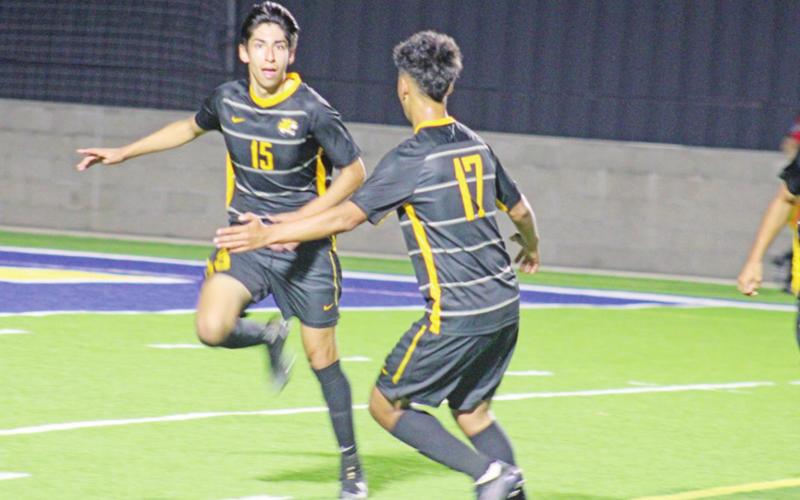Mount Pleasant’s J.D. Mendoza (left) celebrates with Erick Soto after Mendoza’s goal in Tuesday’s area round game at Sulphur Springs against Midlothian. TRIBUNE PHOTO / QUINTEN BOYD