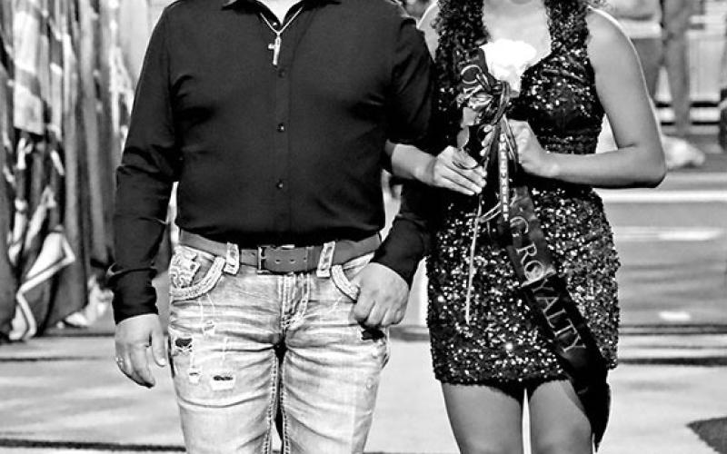 Varsity Football Sweetheart, Pamela Dominguez (right), escorted by her dad, Jose Dominguez