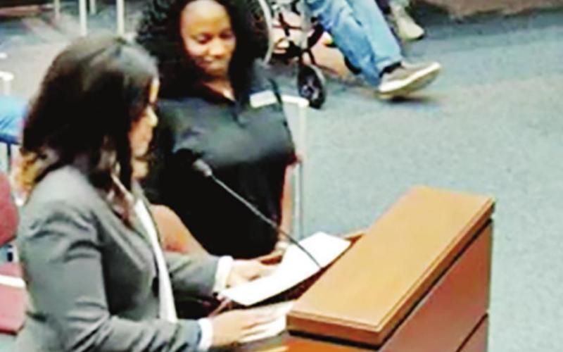 Rea Allen stands with Amer James and reads nomination letters at the City Council meeting on May 3. COURTESY PHOTO