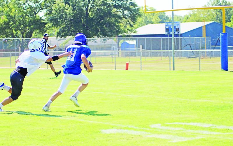 TRIBUNE PHOTO / QUINTEN BOYD Rivercrest’s Cason Fields breaks away from a Detroit defender during Saturday’s scrimmage. Fields would score on the play. The Rebels will scrimmage Maud and Ore City Thursday at the Swamp.