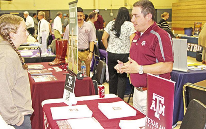 Senior Madison Carpenter speaks to a representative from Texas A&amp;amp;M University.