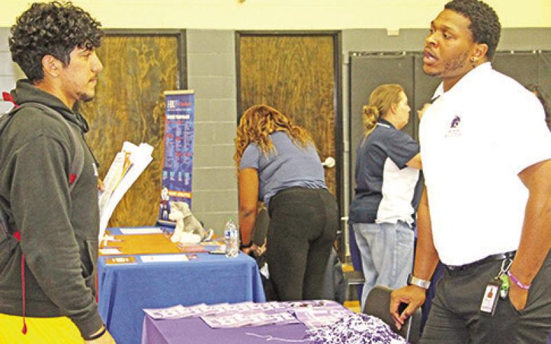Senior Brannon Aguero speaks to the rep from Wiley College.