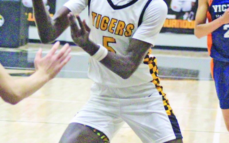 Reggie Webster and the 17th-ranked Mount Pleasant Tigers kicked off district play Tuesday with a win at Hallsville, 56-46. Mount Pleasant is 2-0 in district play, also defeating Whitehouse, 38-20. The Tigers played at home Friday night against Texas High and will take on Pine Tree at home Tuesday. TRIBUNE PHOTO / QUINTEN BOYD