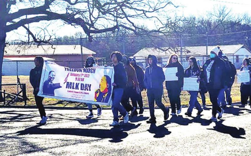 Marchers make their way down MLK Blvd. on Monday headed to Oaklawn Park as a part of the annual remembrance of Dr. Martin Luther King, Jr. TRIBUNE PHOTO / KENNY MITCHELL