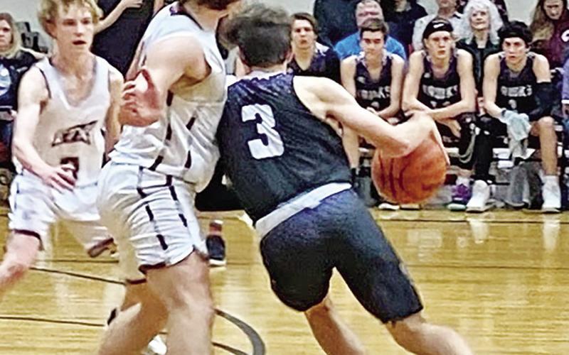 CHAAMP’s Drew Wigley keeps his legs churning to get around an ETHS defender at the top of the key. COURTESY PHOTO