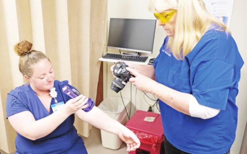 Emily Tonkin, RN and Kim Basinger, RN work with equipment used in SANE examinations. COURTESY PHOTO