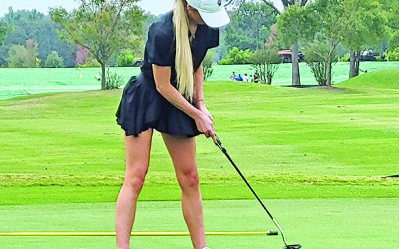 Kylee Strickland putts toward the cup