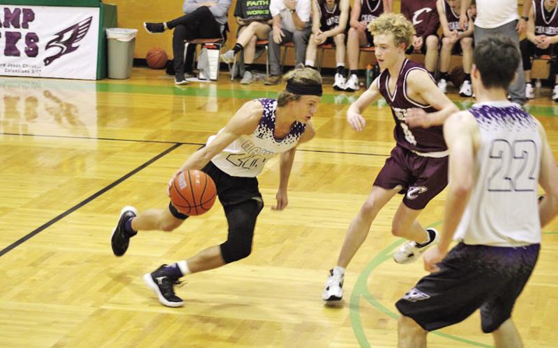 CHAAMP’s John Luke Angier prepares to attack the paint as Conner Frank rushes in to set a pick on Will Mason of ETHS. Angier would finish with 20 points in the win COURTESY PHOTOS