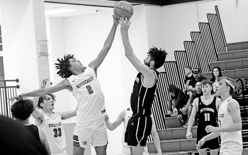 Rivercrest’s Tre Williams blocks a last-second shot attempt at the conclusion of the first overtime during the Rebels’ game against Pittsburg. The Rebels held off the Pirates, 62-61. TRIBUNE PHOTO / QUINTEN BOYD