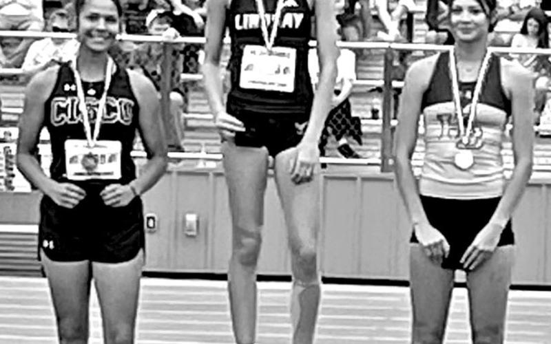 Harts Bluff junior Alexis Gonzalez (right) stands on the podium after winning a silver medal in the high jump with a height of 5-feet, 2-inches at the Class 2A, Region 2 Track &amp;amp; Field Championships in Springtown last week. She will be competing at the UIL State Track &amp;amp; Field Championships in Austin on May 1-3 COURTESY PHOTO