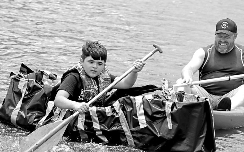 Charles Johnson paddles back to shore with Wallace Assistant Principal, Kelly Inman, available for safety
