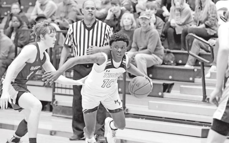 Kelcey Morris looks for room to drive versus Hallsville. PHOTO BY JOHN WHITTEN