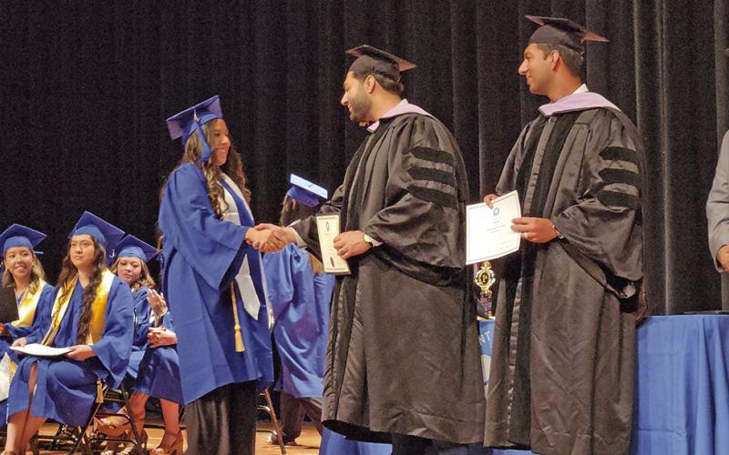 Graduates of Mount Pleasant Dental Assistant School walk the stage