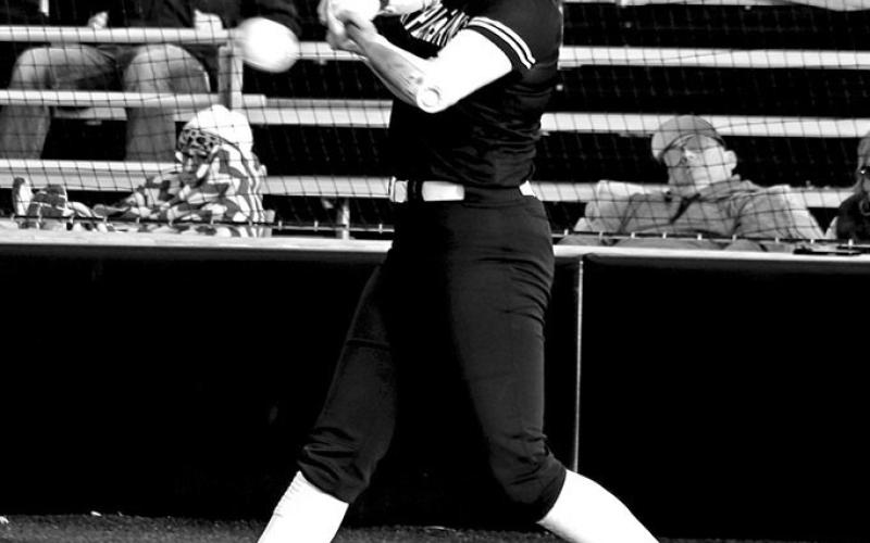 Mount Pleasant freshman Kammie Terrell (1) unloads on a pitch for a home run against New Boston during the Lady Tiger Invitational softball tournament on Thursday night. TRIBUNE PHOTOS / MICHAEL S. MCCRACKEN